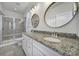 Luxurious bathroom with a double vanity, granite countertops, and a glass-enclosed shower at 1304 E Woodlawn Rd, Charlotte, NC 28209