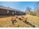 Backyard featuring a set of wooden Adirondack chairs surrounding a fire pit at 13546 W Highway 55 W Hwy, York, SC 29745