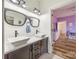 Bathroom with double vanity sinks, black hardware, and unique decor at 13546 W Highway 55 W Hwy, York, SC 29745