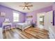 Purple bedroom featuring a ceiling fan, vanity, and hardwood floors at 13546 W Highway 55 W Hwy, York, SC 29745