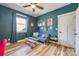 Unique bedroom with blue walls, hardwood floors, and a small blue sofa at 13546 W Highway 55 W Hwy, York, SC 29745