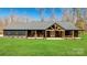 Beautiful modern farmhouse with dark siding, a covered porch, and a well-manicured lawn at 13546 W Highway 55 W Hwy, York, SC 29745