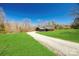 Charming exterior view of home with a long gravel driveway, green lawn, and a covered porch at 13546 W Highway 55 W Hwy, York, SC 29745