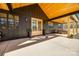 Inviting front porch with double glass doors, concrete flooring, and natural wood ceiling at 13546 W Highway 55 W Hwy, York, SC 29745