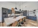 Modern kitchen with a large island, pendant lighting, stainless steel appliances, and wood flooring at 13546 W Highway 55 W Hwy, York, SC 29745