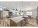 Open concept living space with a modern kitchen, fireplace, staircase, and ample seating at 13546 W Highway 55 W Hwy, York, SC 29745