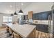 Open concept living space with a modern kitchen, dining area, and stylish lighting fixtures at 13546 W Highway 55 W Hwy, York, SC 29745