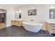 Luxurious main bathroom with a freestanding tub, modern vanities, and black hexagon tile flooring at 13546 W Highway 55 W Hwy, York, SC 29745