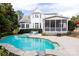 Gorgeous backyard showcasing an in-ground pool, screened porch, and lush landscaping at 152 Bay Shore Loop, Mooresville, NC 28117