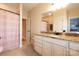A bright bathroom features granite counters, neutral tile floors, and a shower with decorative curtain at 152 Bay Shore Loop, Mooresville, NC 28117