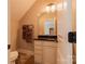 Well-lit bathroom featuring a granite countertop, white cabinetry, and tiled floors at 152 Bay Shore Loop, Mooresville, NC 28117