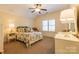 A bright bedroom is furnished with patterned bedding, lamps, and white dressers at 152 Bay Shore Loop, Mooresville, NC 28117