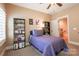 Bedroom featuring neutral colors, a ceiling fan, a bed, shelving units and a view to the hallway at 152 Bay Shore Loop, Mooresville, NC 28117