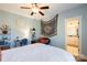 Bedroom with light-blue walls featuring shelves, desk, a cozy chair, a dream catcher and a view to the bathroom at 152 Bay Shore Loop, Mooresville, NC 28117