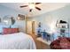 Bedroom with light-blue walls featuring a ceiling fan, shelves, a cozy chair and a study desk at 152 Bay Shore Loop, Mooresville, NC 28117
