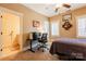 Bedroom featuring neutral colors, a ceiling fan, a desk and a view to the bathroom through the door at 152 Bay Shore Loop, Mooresville, NC 28117