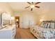 This neutral bedroom has a ceiling fan, two dressers, and patterned bedding at 152 Bay Shore Loop, Mooresville, NC 28117