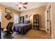 Bedroom featuring neutral colors, ceiling fan, a desk, shelving units and a view to the hallway at 152 Bay Shore Loop, Mooresville, NC 28117