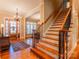 Inviting foyer featuring hardwood floors, staircase and elegant chandelier at 152 Bay Shore Loop, Mooresville, NC 28117