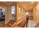 Upper hallway featuring hardwood floors, wrought iron railings, and arched display niches on the walls at 152 Bay Shore Loop, Mooresville, NC 28117