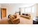 Spacious living room featuring plush sofas, neutral carpeting, mini bar, and sunlit bay windows at 152 Bay Shore Loop, Mooresville, NC 28117