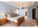 Comfortable main bedroom features natural light, a chandelier and en-suite bathroom at 152 Bay Shore Loop, Mooresville, NC 28117