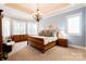 Spacious main bedroom with a chandelier, large windows, and sitting area at 152 Bay Shore Loop, Mooresville, NC 28117