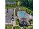 Aerial view of a community pool and playground with well-maintained landscaping at 15237 Red Canoe Way, Charlotte, NC 28278