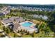 Scenic aerial view showcasing community amenities including a pool, playground, and pond at 15237 Red Canoe Way, Charlotte, NC 28278
