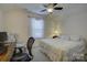 Cozy bedroom featuring a comfortable bed, ceiling fan, and a dedicated workspace with a desk at 15237 Red Canoe Way, Charlotte, NC 28278