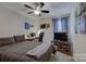 Comfortable bedroom with a large bed, a desk, and a ceiling fan at 15237 Red Canoe Way, Charlotte, NC 28278