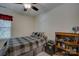 Comfortable bedroom with a bed and storage shelves, lit by a ceiling fan at 15237 Red Canoe Way, Charlotte, NC 28278