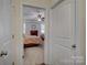 Bright bedroom featuring neutral carpet, ceiling fan, and large windows for natural light at 15237 Red Canoe Way, Charlotte, NC 28278
