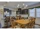 Bright dining area featuring dark cabinets, modern lighting, and hardwood floors at 15237 Red Canoe Way, Charlotte, NC 28278