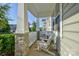 Inviting screened front porch features stone pillars and comfortable seating at 15237 Red Canoe Way, Charlotte, NC 28278