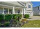 Beautifully landscaped front yard showcasing mature plantings and flowering accent plants at 15237 Red Canoe Way, Charlotte, NC 28278