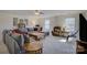 Spacious living room with plush seating, a ceiling fan, and abundant natural light at 15237 Red Canoe Way, Charlotte, NC 28278