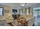 Cozy living room with fireplace, plush seating, and natural light from sliding glass doors at 15237 Red Canoe Way, Charlotte, NC 28278