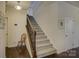 Inviting foyer showcasing hardwood floors and a carpeted staircase with decorative iron railings at 15237 Red Canoe Way, Charlotte, NC 28278