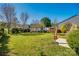 Lush backyard with manicured lawn, privacy fence, and patio area, ideal for outdoor activities at 1612 Beleek Ridge Ln, Clover, SC 29710