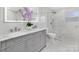 Elegant bathroom featuring marble walls and floors, double vanity, and a glass-enclosed shower at 1612 Beleek Ridge Ln, Clover, SC 29710