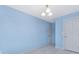 Bright bedroom features blue walls, light wood floors, and updated lighting at 1612 Beleek Ridge Ln, Clover, SC 29710