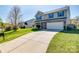 Charming two-story home with a wide driveway, attached garage, and well-maintained lawn at 1612 Beleek Ridge Ln, Clover, SC 29710
