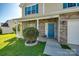 Inviting front entrance featuring a brick facade, blue door, and a meticulously landscaped yard at 1612 Beleek Ridge Ln, Clover, SC 29710