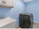 Well-equipped laundry room with modern black washer/dryer and utility sink at 1612 Beleek Ridge Ln, Clover, SC 29710