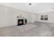 Bright living room featuring a cozy fireplace and large windows, complemented by stylish flooring at 1612 Beleek Ridge Ln, Clover, SC 29710