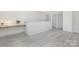 A room with modern brickwork, hardwood floors, and a modern light fixture at 1612 Beleek Ridge Ln, Clover, SC 29710