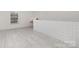 A room with modern brickwork, hardwood floors, and ample lighting through a window at 1612 Beleek Ridge Ln, Clover, SC 29710