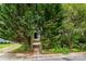 Charming home featuring mature trees, front entry stairs and a lush garden surrounding the pathway to the front door at 1716 Umstead St, Charlotte, NC 28205