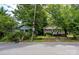 Street view of homes with mature shade trees and landscaping, as well as sidewalks and paved streets at 1716 Umstead St, Charlotte, NC 28205